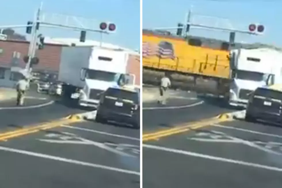 Freight Train and Semi-Truck Meet at Railroad Crossing