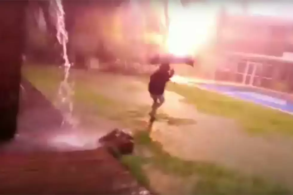 Lightning Nearly Strikes Kid Showing Off Umbrella in a Storm