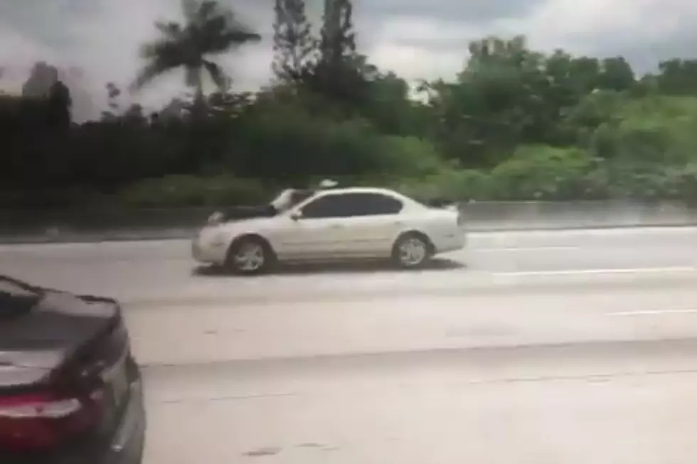 Another Man Rides Along Florida Interstate On Car Hood