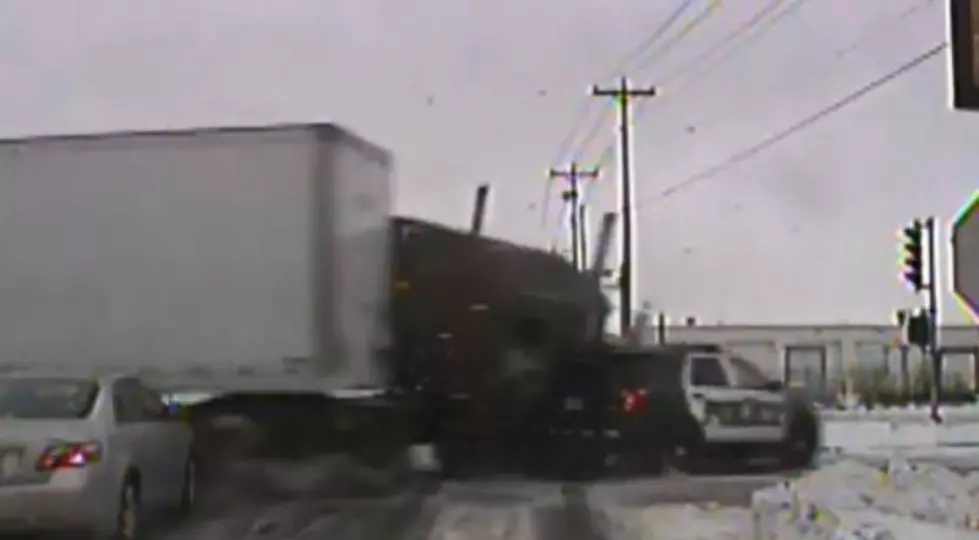 Semi Runs Red Light and Crashes Into Police Cruiser