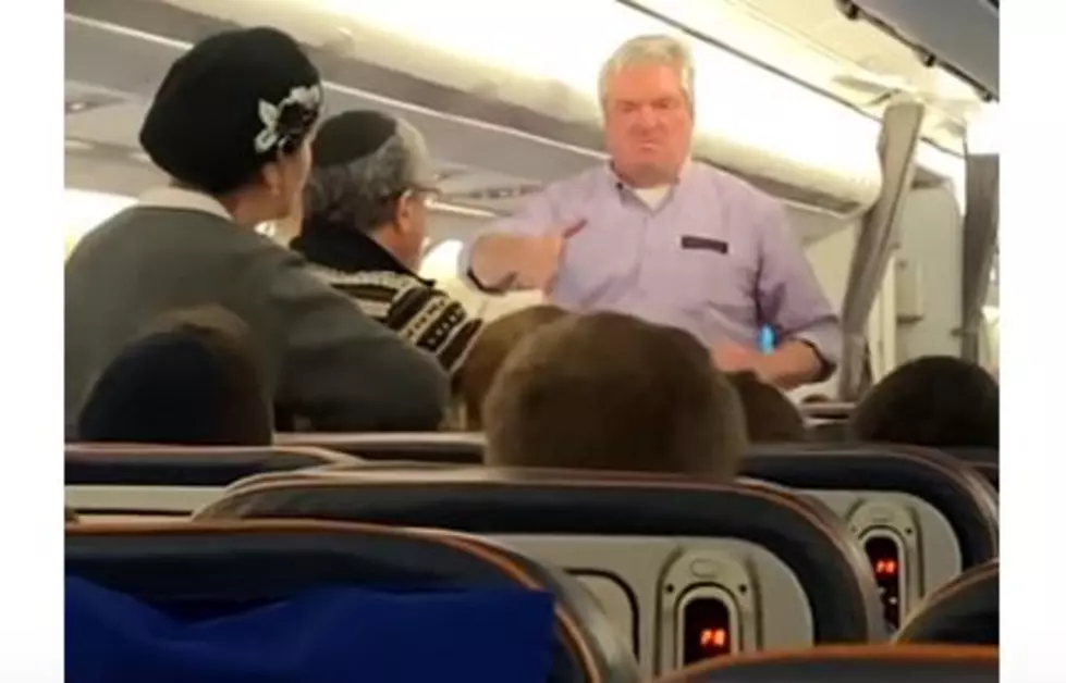 Angry Guy on a Plane Aggressively Tries to Shake Someone’s Hand