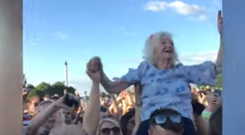 Grandma Rocking Out on Someone’s Shoulders at a Music Festival
