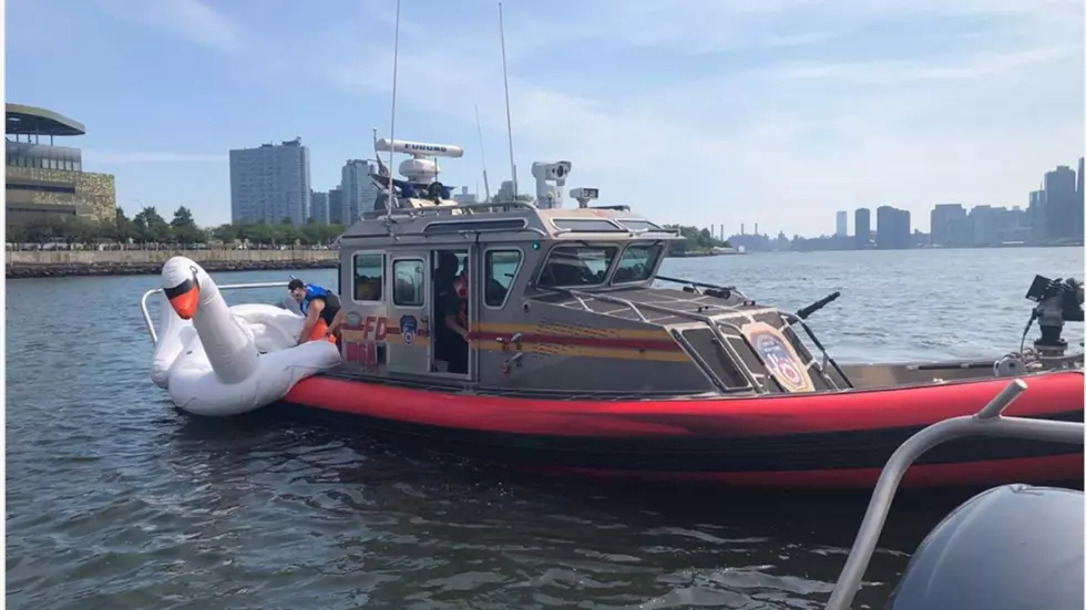 FDNY Rescues Two People And Their Inflatable Swan Float in East River