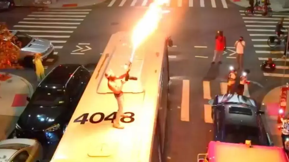 Guy Shoots Flamethrower From Roof of New York City Bus