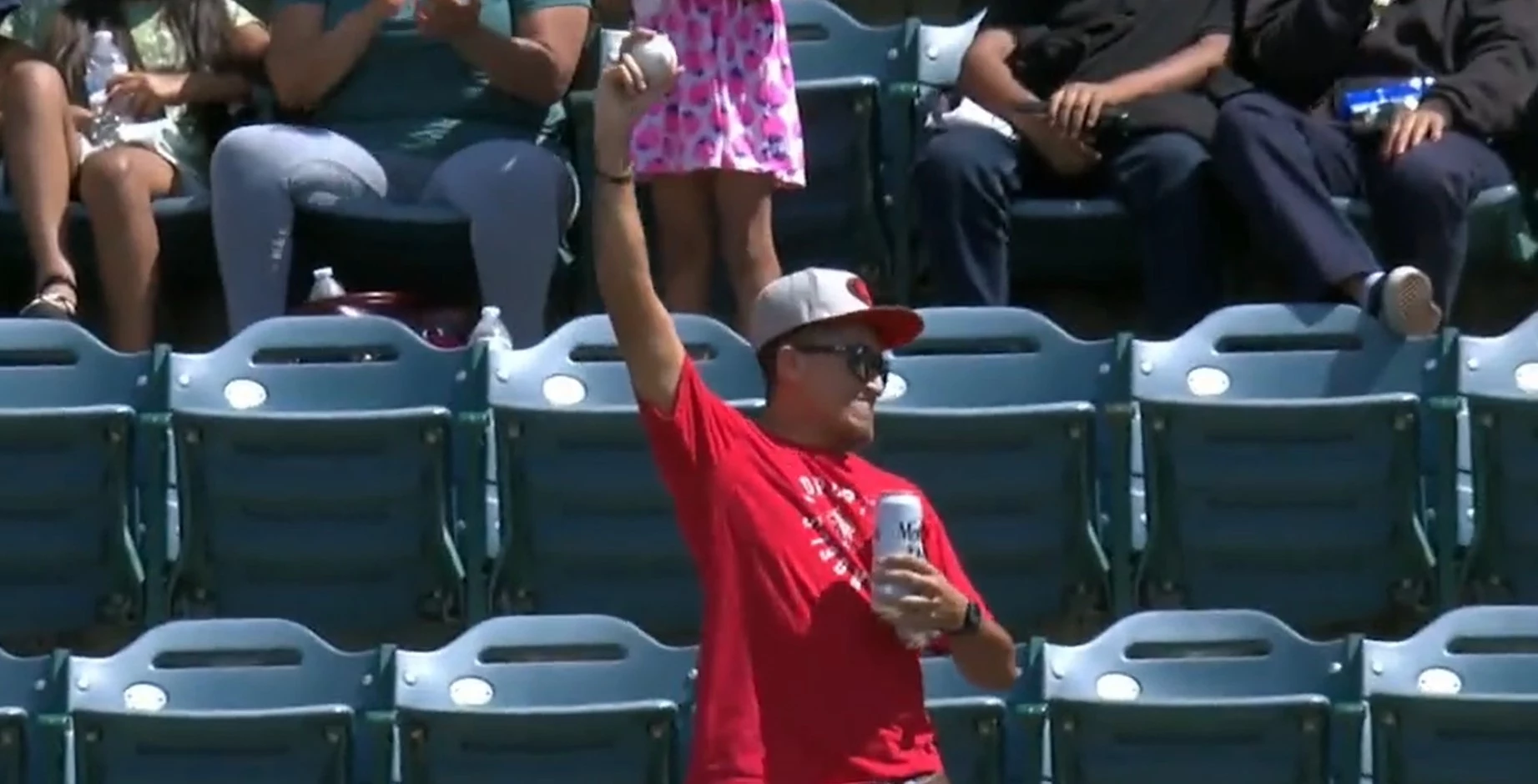 Dodgers fan catches home run with her hat while holding a beer in