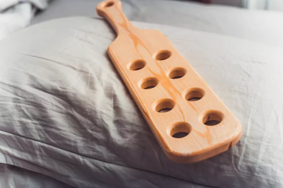 school spanking wooden paddle on pillow prepared for spanking