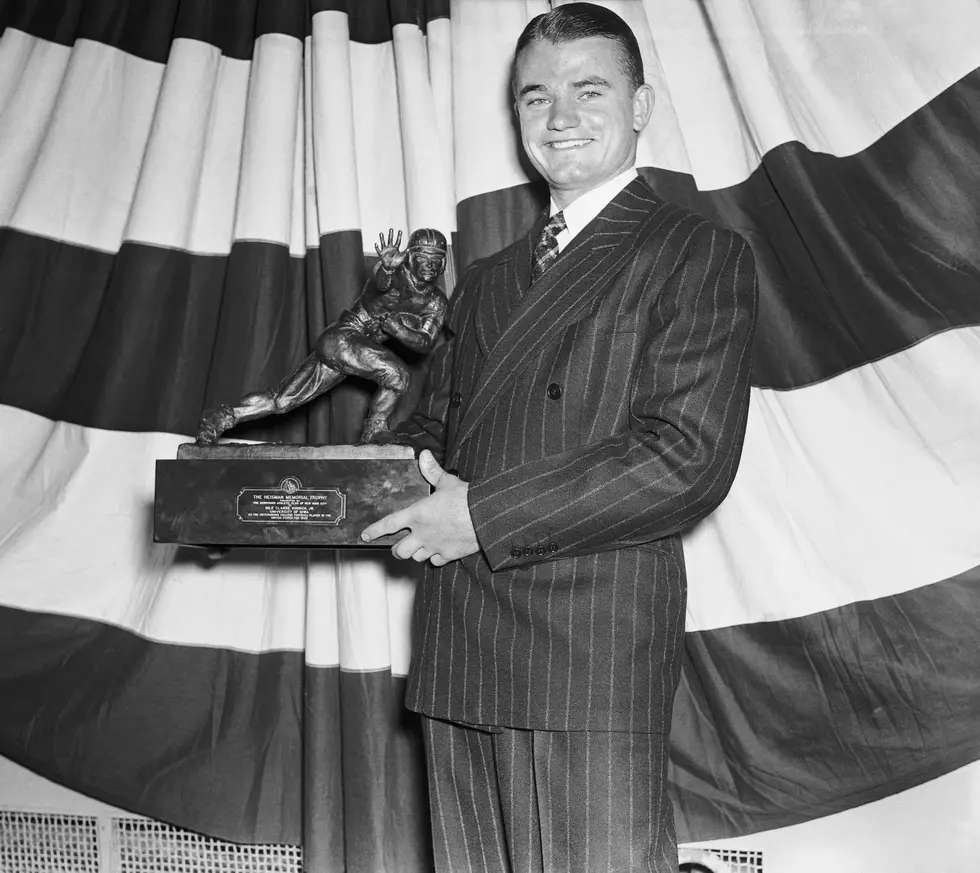 Clarke Kinnick Jr. Holding Trophy