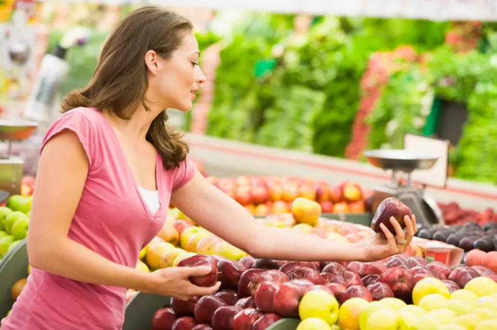Woman shopping for apples at a grocery store