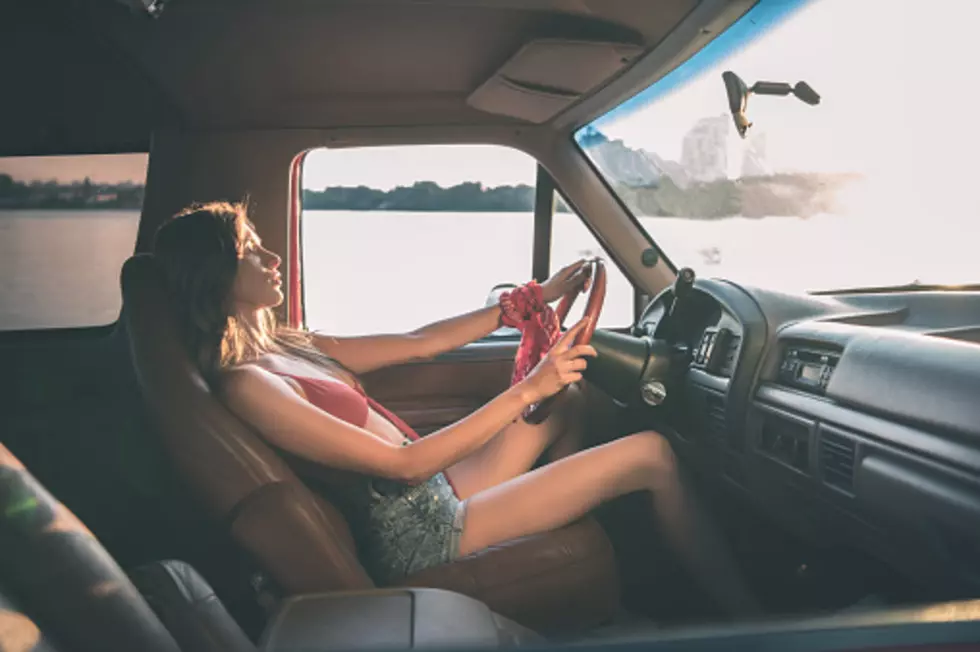 young beautiful woman driving car
