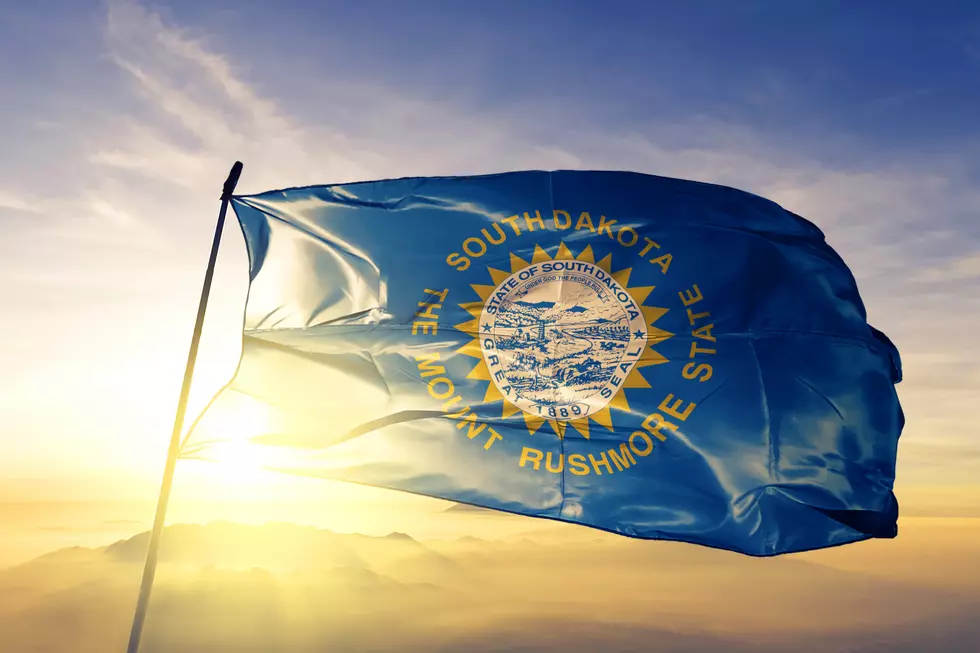 South Dakota state of United States flag textile cloth fabric waving on the top sunrise mist fog