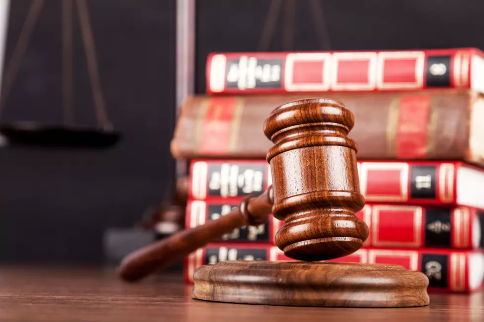 Close-up of Wooden gavel with golden scales of justice and books on background