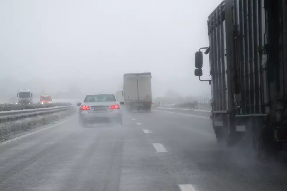 cars, trucks and rescue vehicle driving in dangerous winter weather