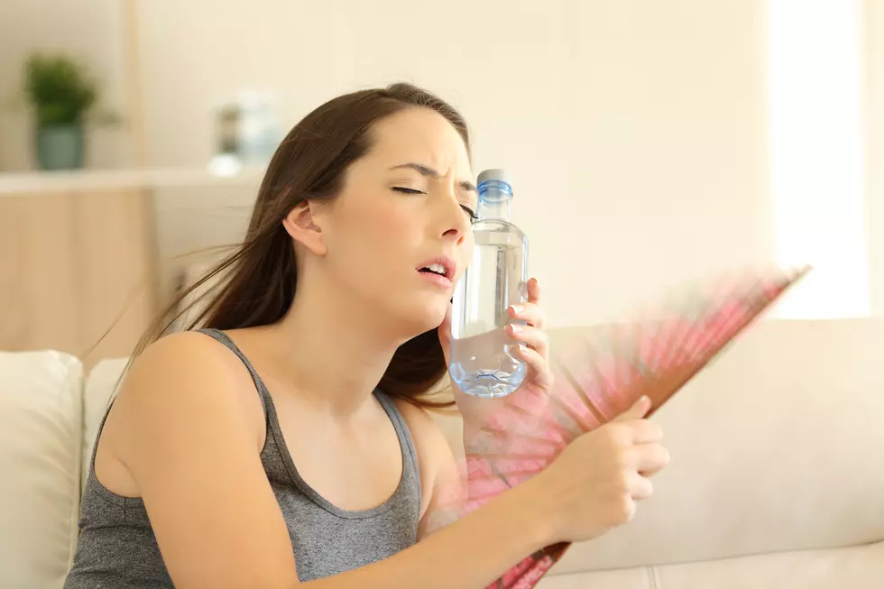 Girl suffering a heatstroke refreshing with a fan