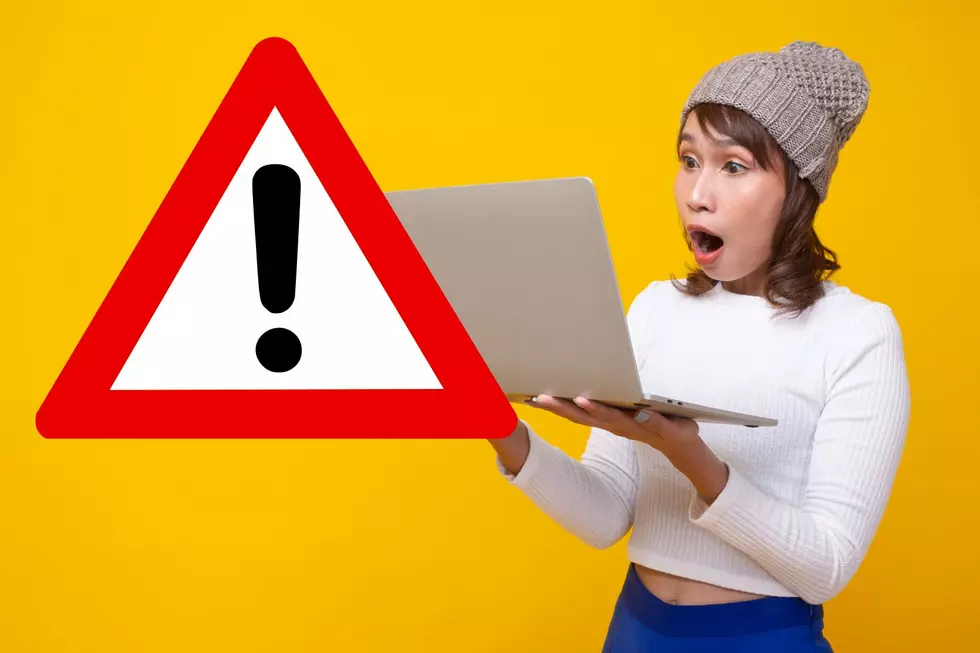 woman staring shocked her laptop