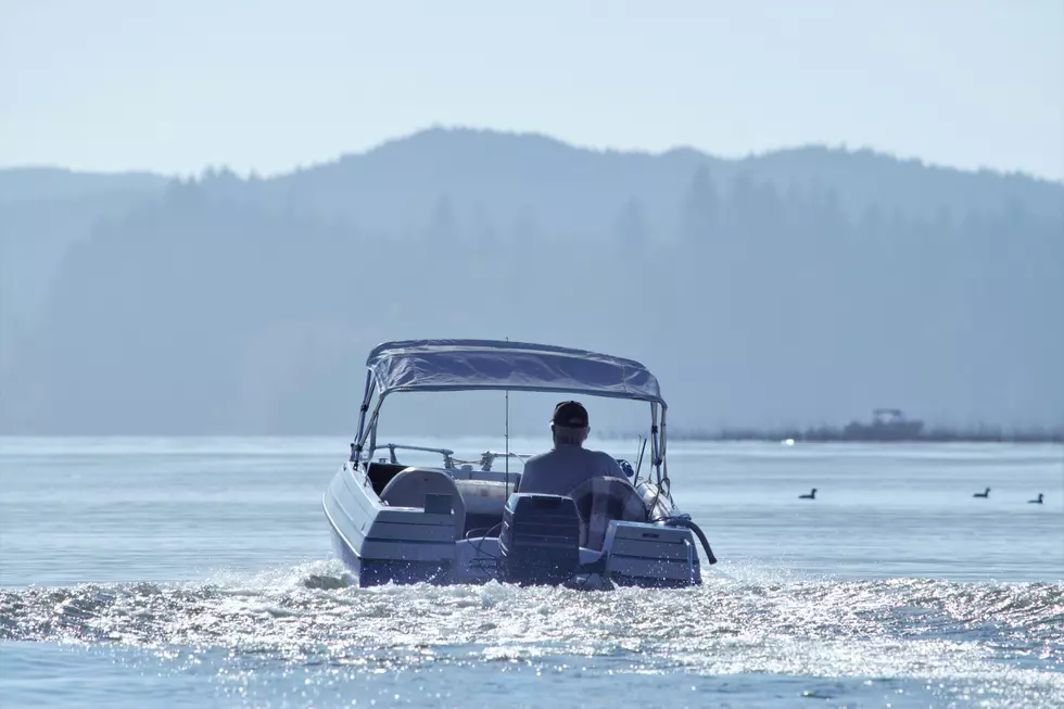 a man driving away on a boat
