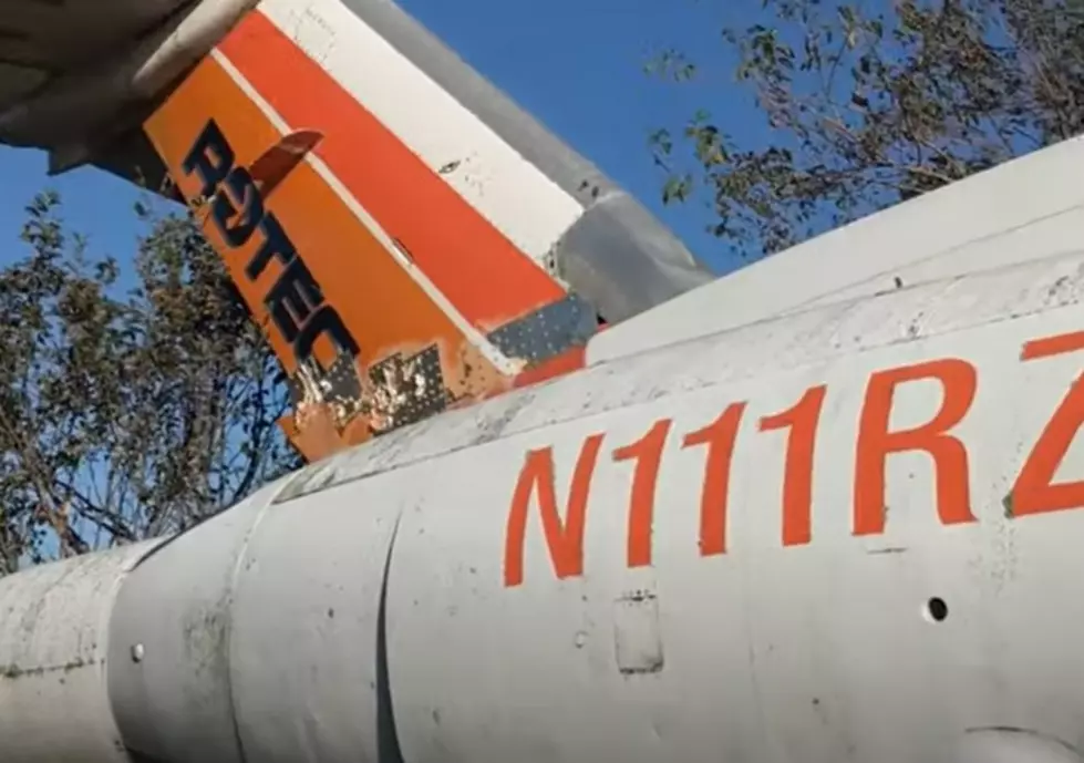 There is a private jet left abandoned off of a highway in Illinois.