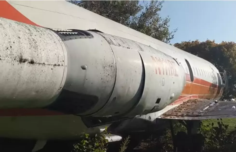 There is a private jet left abandoned off of a highway in Illinois.