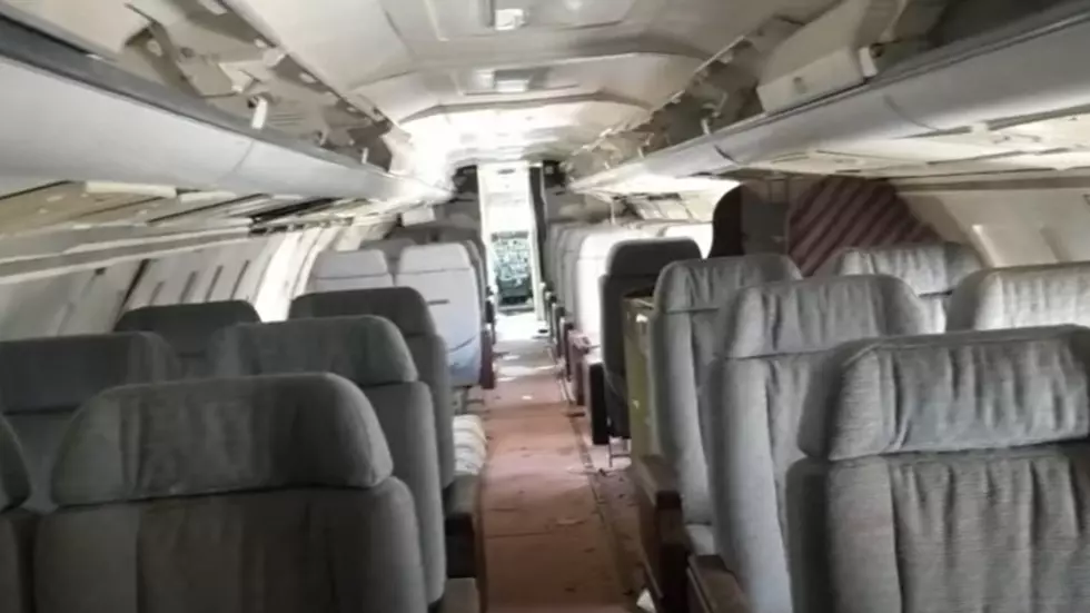 There is a private jet left abandoned off of a highway in Illinois.