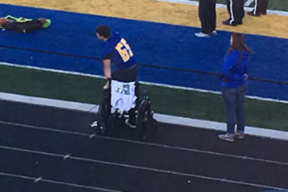 Wheelchair-Bound Football Player Stands for National Anthem