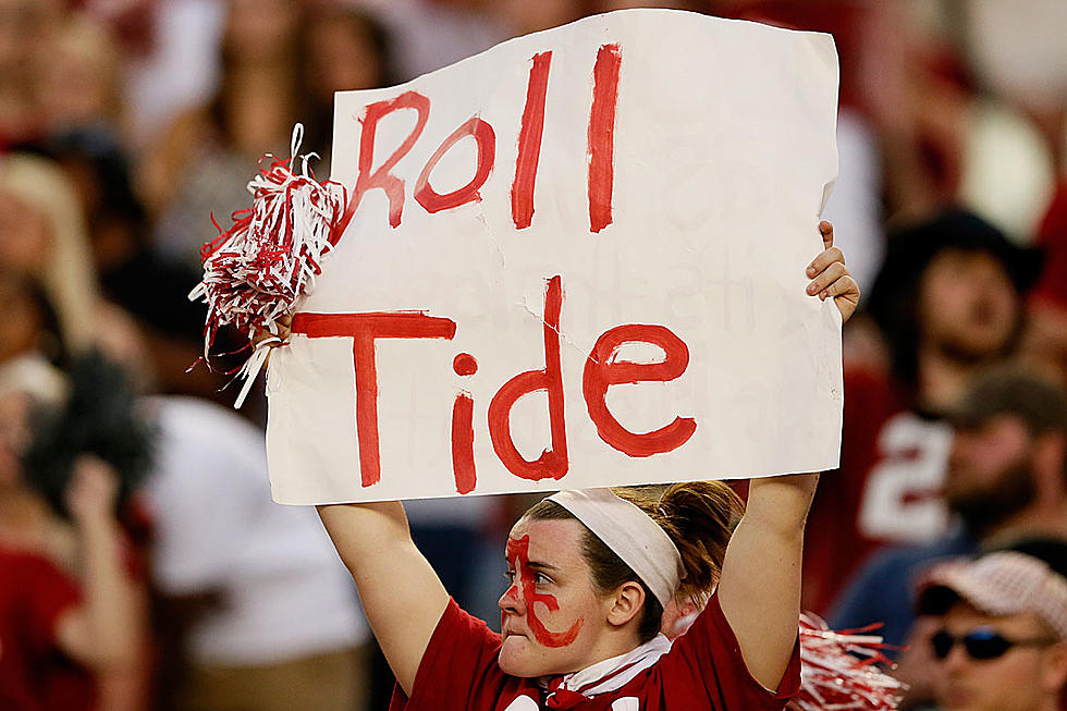 Alabama Fan Can&#8217;t Resist Sneaking in a &#8216;Roll Tide&#8217; While Getting Arrested on Live TV
