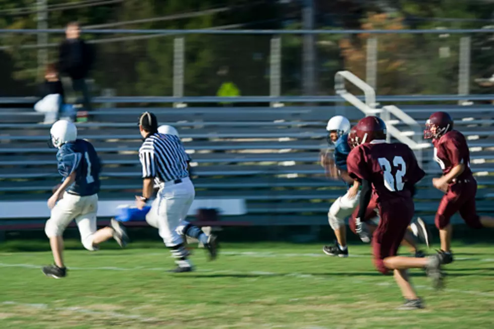 High school football players on the way to a first down.