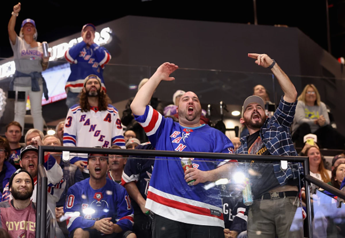 Fans cheer on the New York Rangers as they take the ice to warm