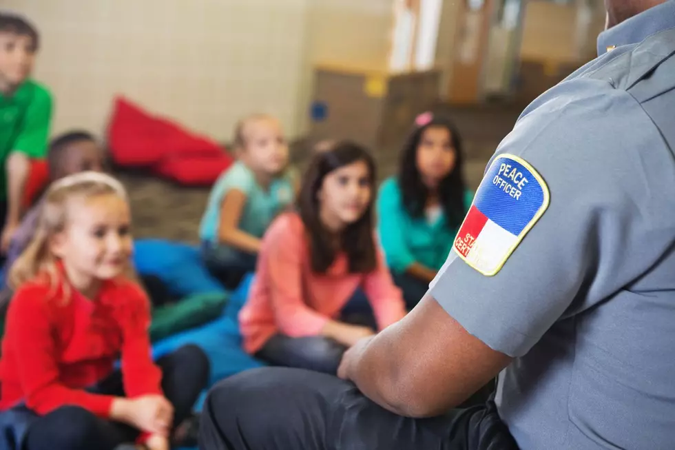 A peace officer speaking with children