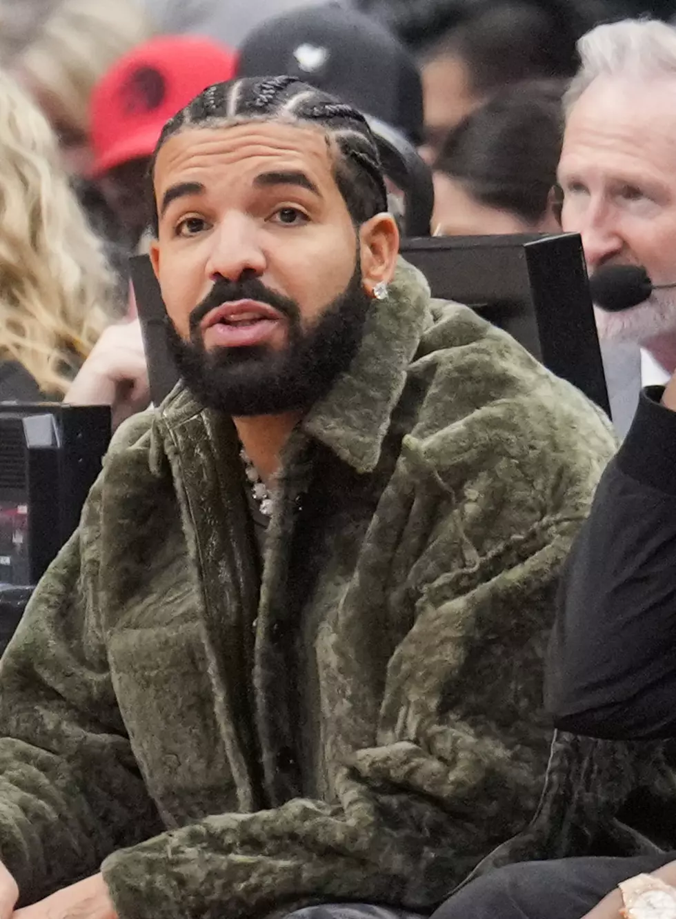 Drake sits with Baka Not Nice as the Toronto Raptors play the Houston Rockets during their basketball game at the Scotiabank Arena on April 8, 2022 in Toronto, Ontario, Canada.