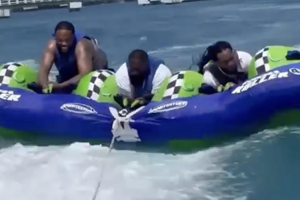 Rick Ross Hangs on for Dear Life While Being Towed on Water Tube – Watch
