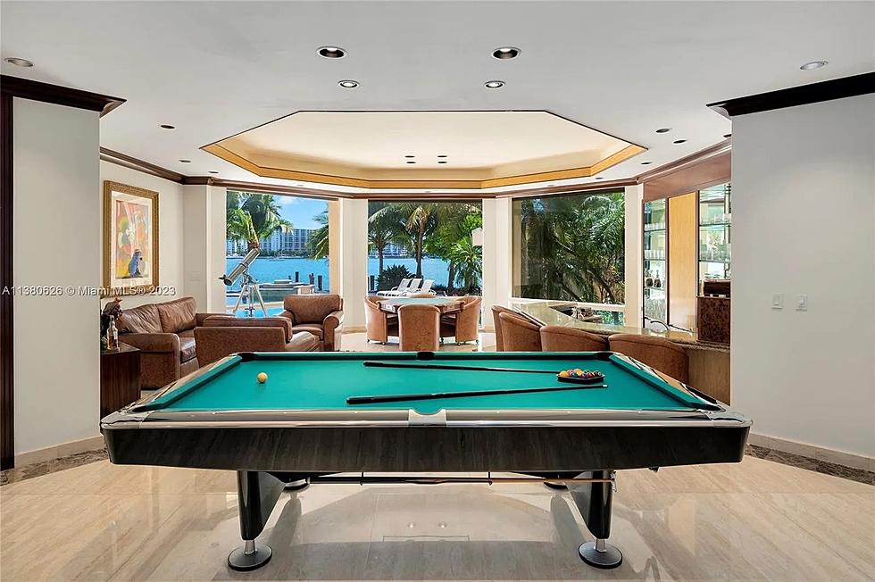 Pool table leading to a sitting area that overlooks the bay