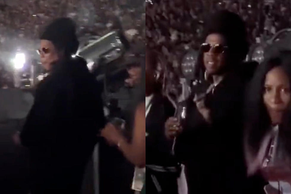 Jay Z pauses his performance at the Louis Vuitton show to check