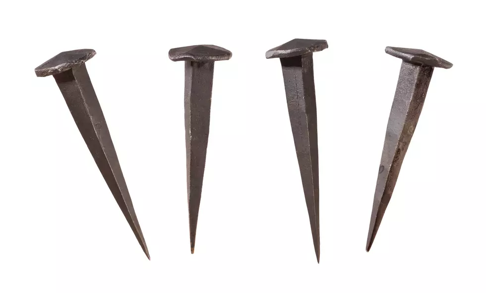 Four Antique Handmade Nails Displayed at different angles.