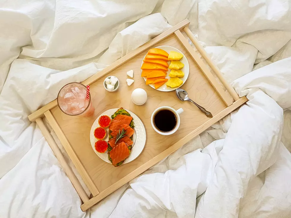 Wooden breakfast table on the bed in the bedroom on a day off. High quality photo