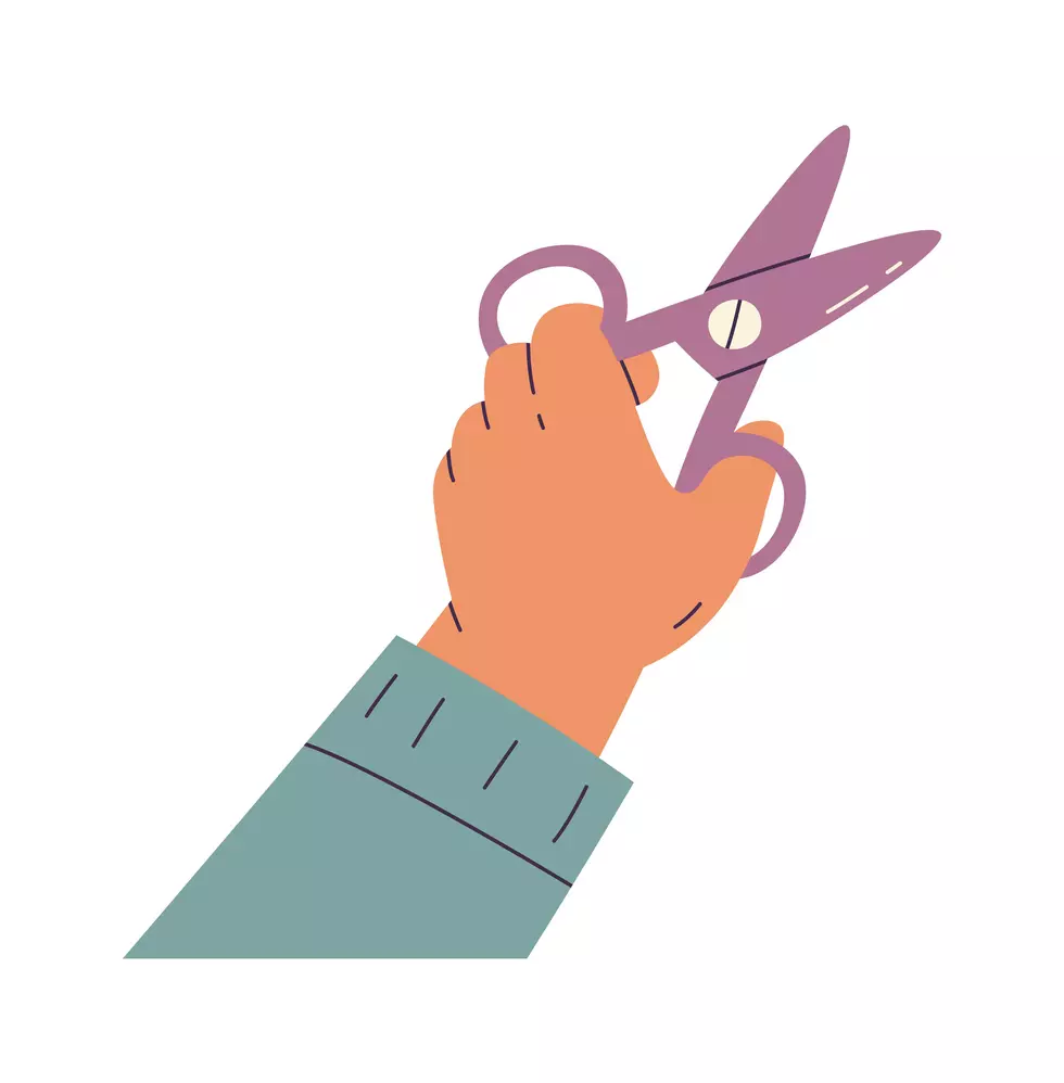 Small child hand hold scissors