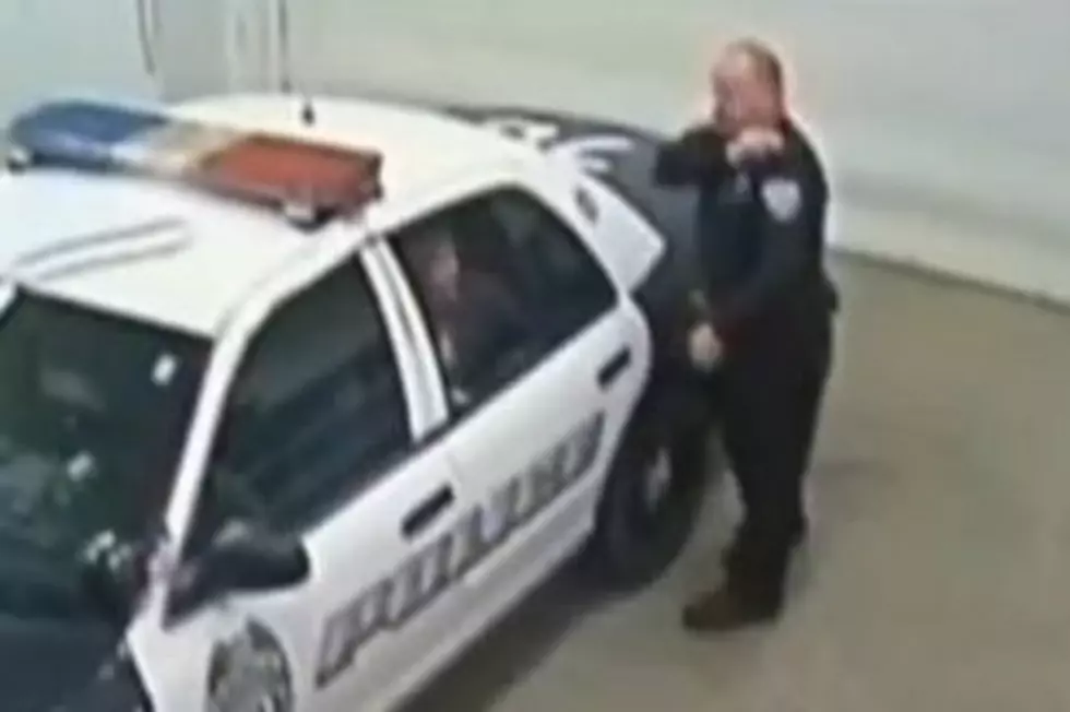 Angry Woman Kicks Out Police Car Window [VIDEO]