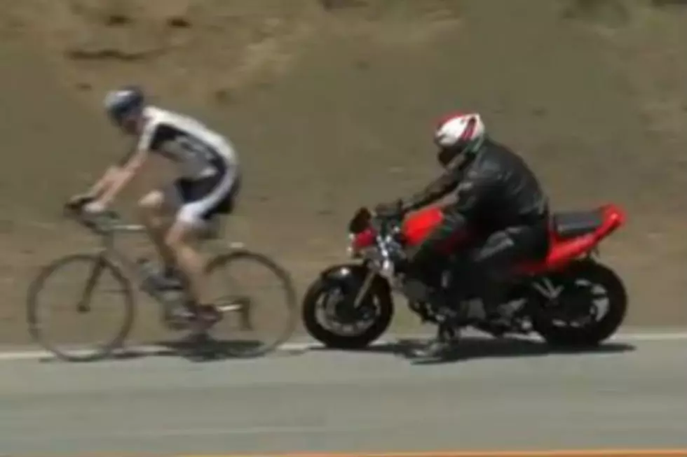 Motorcycle Crashes Into Bicycle During Race