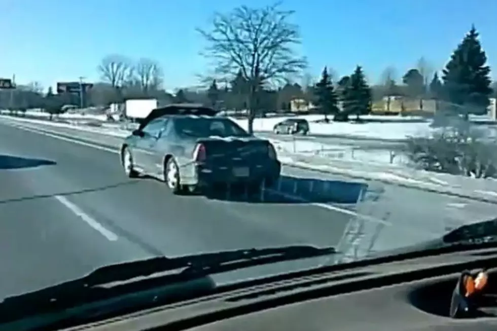 Guy Drives Down The Highway With Hood Pressed Against The Windshield [VIDEO]