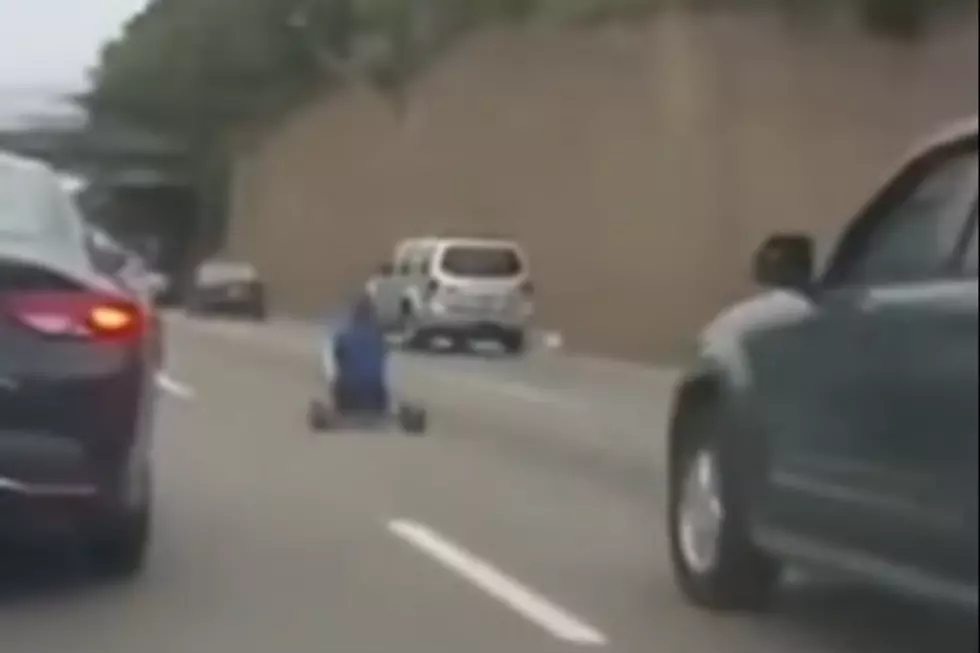 Man Drives Big Wheel On Busy Highway [VIDEO]