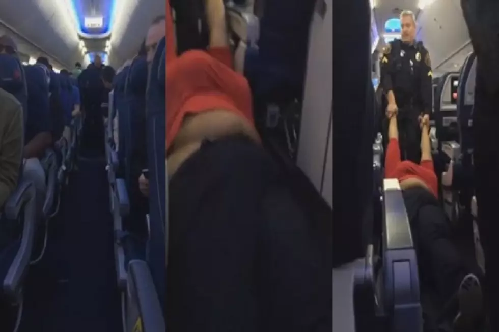 Woman Dragged Off Of Detroit Metro Airplane After Refusing To Check Bag [VIDEO]