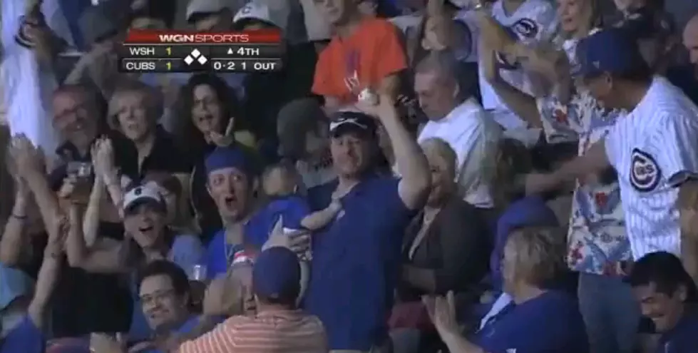 Fan Catches Foul Ball While Holding Baby [Video]