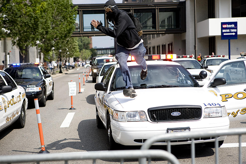 Man Tries to Impress His Friends by Standing on a Police Car, Gets Arrested