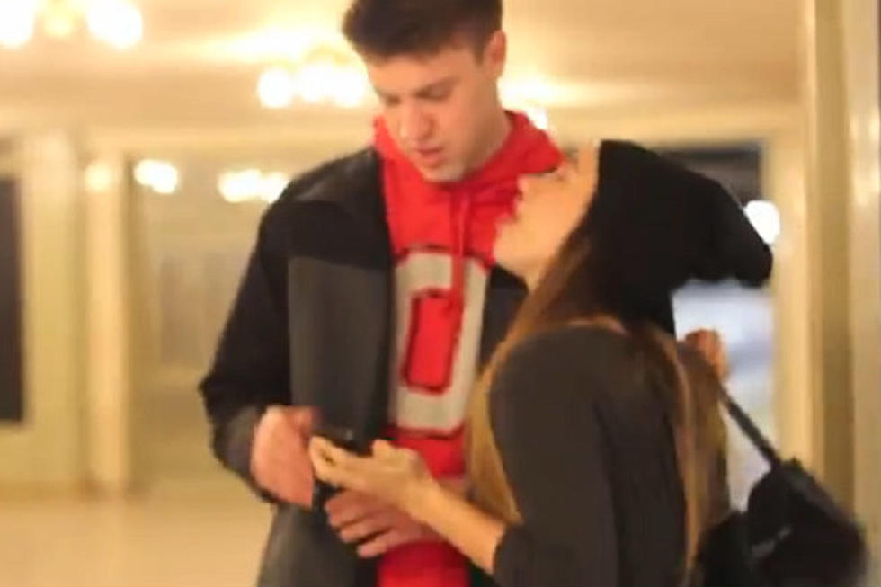 Girl Attempts To Kiss Unsuspecting Strangers In Grand Central Station [Video]