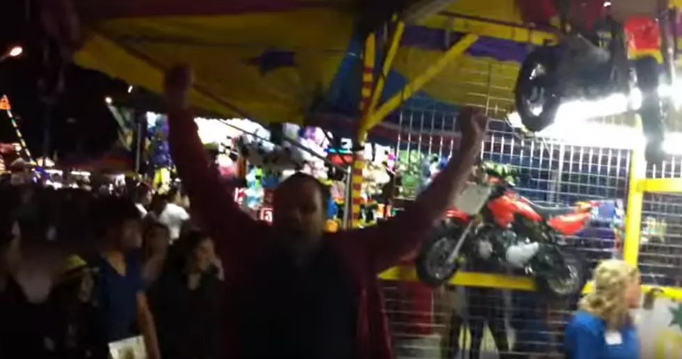 Guy Wins Mini Bike From Carnival Game [Video]