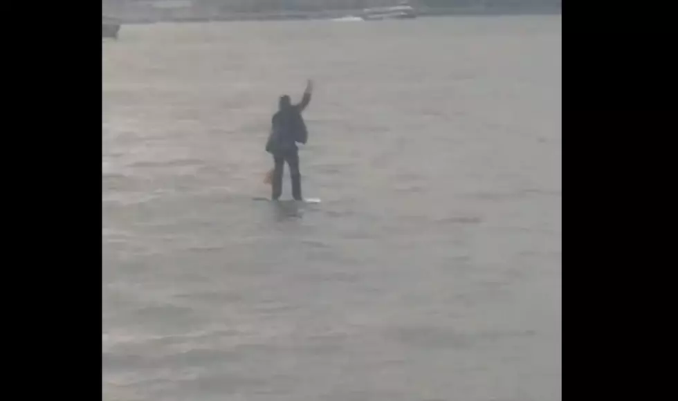Man Paddle Boards Across Hudson River in Suit