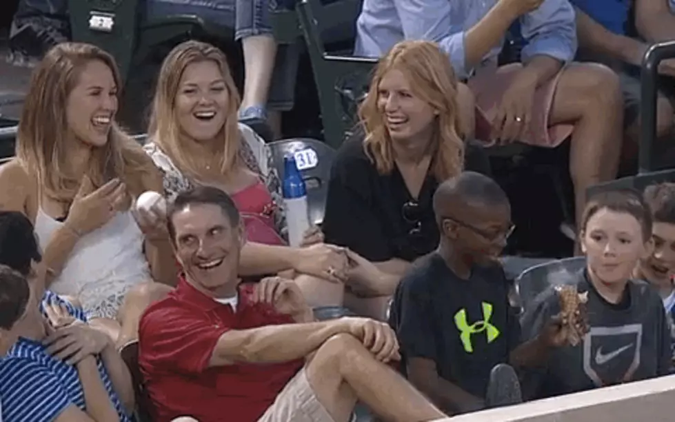 Young Boy Uses Smoothest Foul Ball Trick Ever To Hit On A Young Woman [VIDEO]
