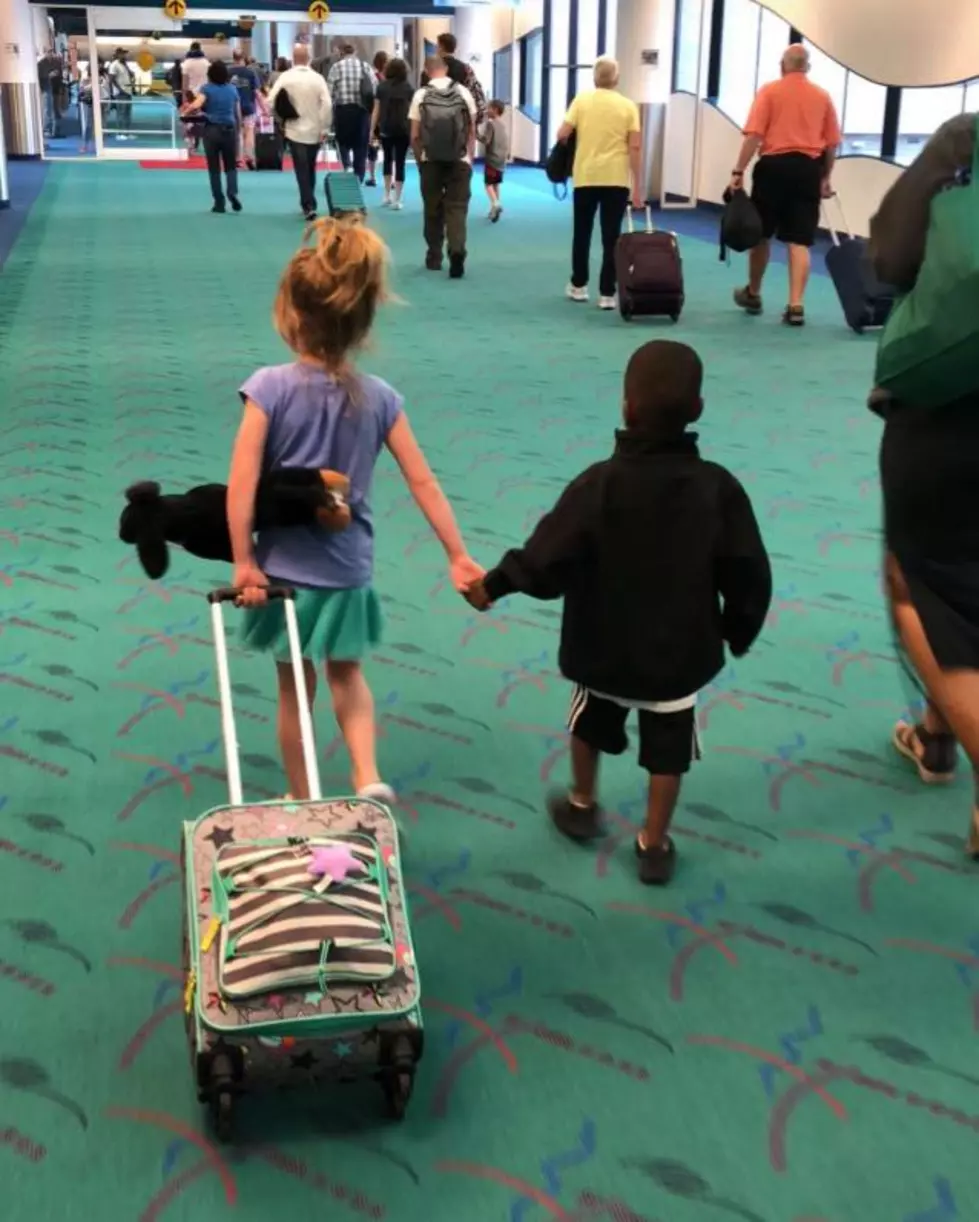 Adorable Photo of Two Kids Holding Hands at Flint Airport 