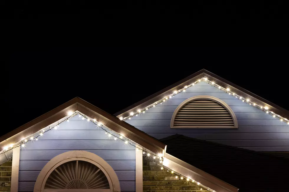 Christmas lights hanging from roof of house