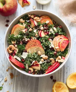 Harvest Kale Caesar Salad With Pomegranate Seeds and Cranberries