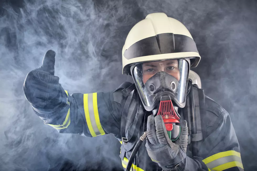 Firewoman in fire protection suit and mask