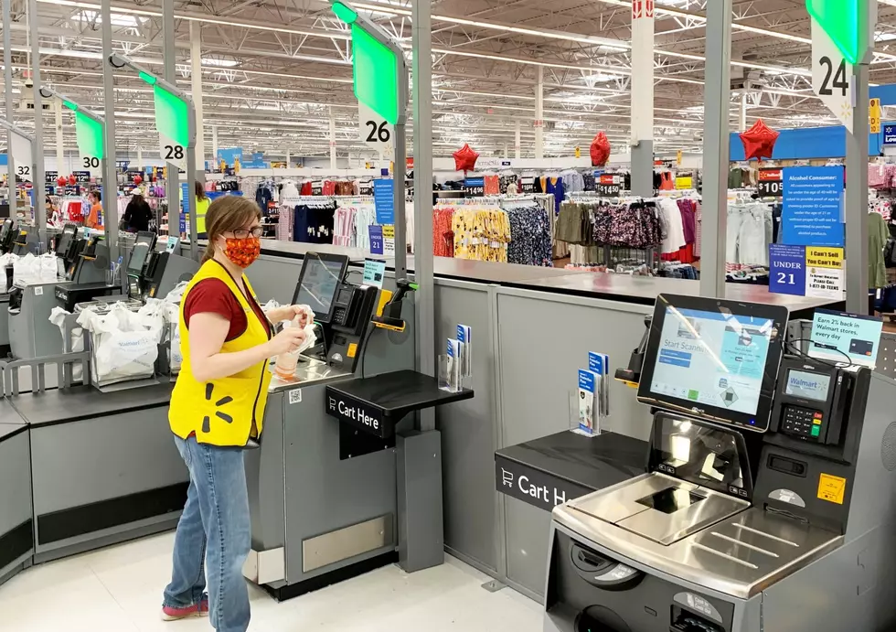 A row of self-checkouts at a Walmart.